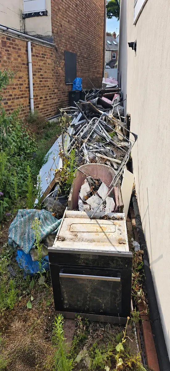 Side passage filled with bulky waste before clearance